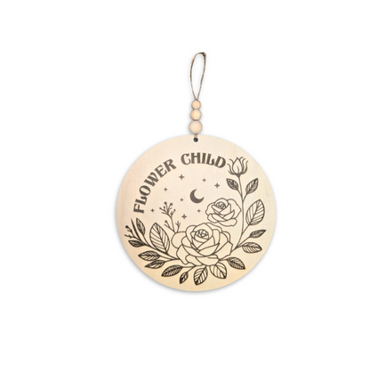 Full view of a wooden sign engraved with 'Flower Child,' adorned with floral and celestial details, perfect for adding a whimsical touch to a child's room or nursery