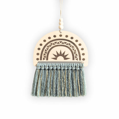 Semi-circle wooden sign with an engraved rainbow design and sage green and gold tassels, displayed on a plain background.