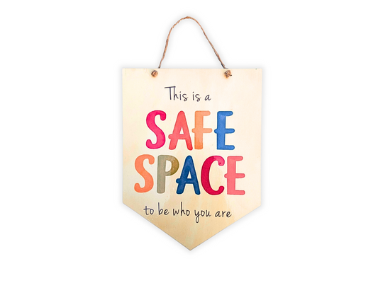 'This is a Safe Place to Be Who You Are' wooden affirmation sign, colorful with a shiny laminated finish, displayed on a plain background.