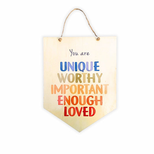 You Are Unique, Worthy, Important, Enough, Loved' wooden affirmation sign, colorful with a shiny laminated finish, displayed on a plain background.