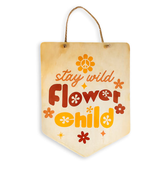  A wooden sign displaying the phrase "Stay Wild, Flower Child." The sign is crafted from premium wood with a natural finish, and the lettering features vibrant warm reds and oranges, shown against a plain background to emphasise its message and design.